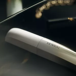 Lash Conditioner on black surface in lifestyle setting